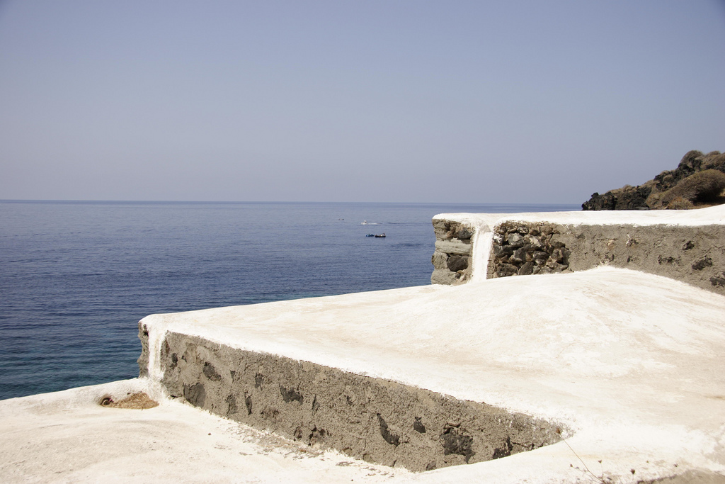 Whitewashed lava bathing terrace above the sea at Cala Nikà, a coastal thermal spot on Pantelleria