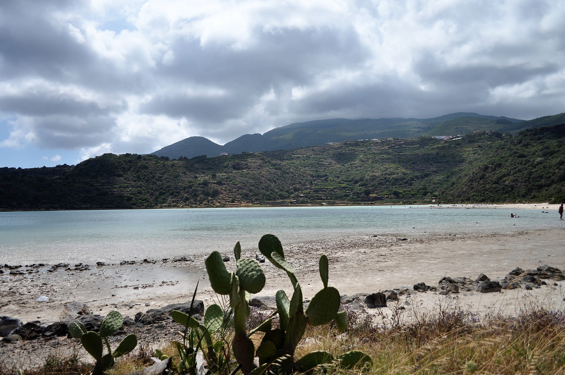 Turquoise Lago di Venere thermal lake and its white mineral shore, a natural hot spring on Pantelleria